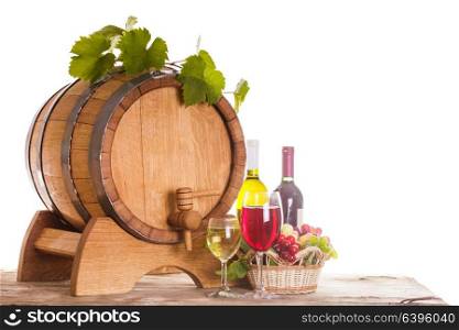 Grapes and bottels of wine near the wooden barrel. Glasses of wine on the table, concept of winery - red and white. concept of winery