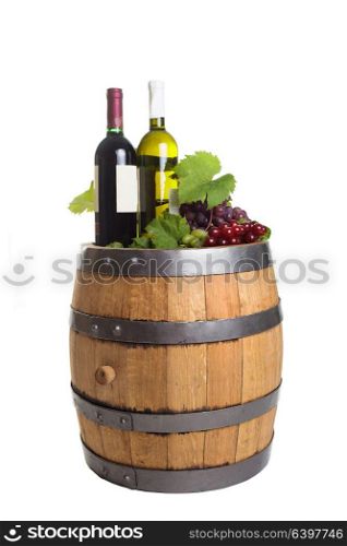 Grapes and bottles on wooden barrel with wine isolated on white. Winery wooden barrel