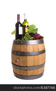 Grapes and bottles on wooden barrel with wine isolated on white. Winery wooden barrel