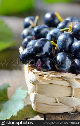 grapes in a basket on wooden background