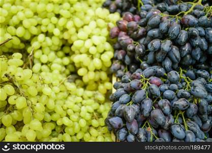 Grapes on the Market.  fresh green grapes and purple grapes.