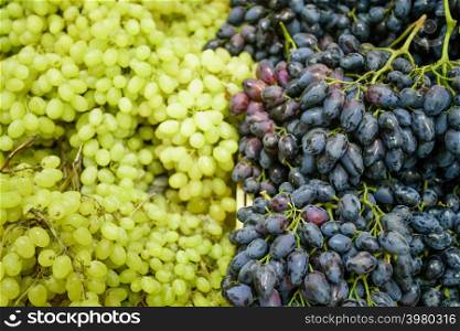 Grapes on the Market. fresh green grapes and purple grapes.