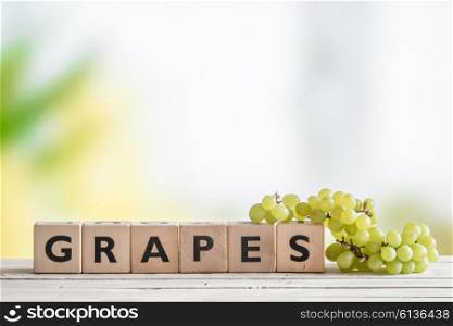 Grapes sign with green grapes on a table