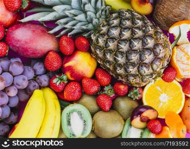 Grapes; strawberries; pineapple; kiwi; apricot; banana and whole pineapple