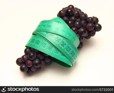 grapes with measure tape on white background