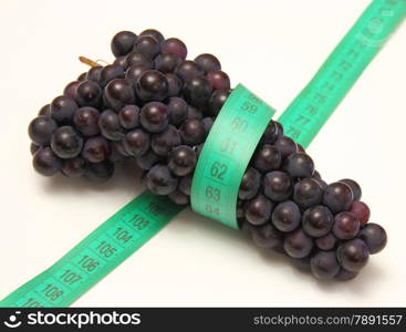 grapes with measure tape on white background