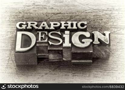 graphic design word abstract in mixed vintage metal type printing blocks over grunge wood, black and white image