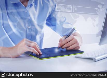 Graphic designer at work. Graphic designer drawing something on tablet at office