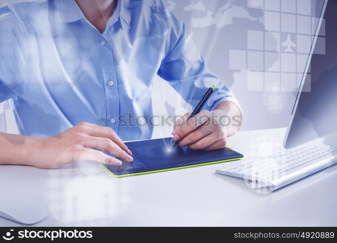 Graphic designer at work. Graphic designer drawing something on tablet at office