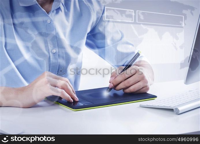Graphic designer at work. Graphic designer drawing something on tablet at office