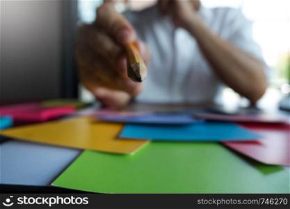 Graphic designer choose colors from the color bands samples for design .Designer graphic creativity working concept.