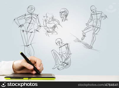 Graphic designer. Close up of human hand using tablet for drawing