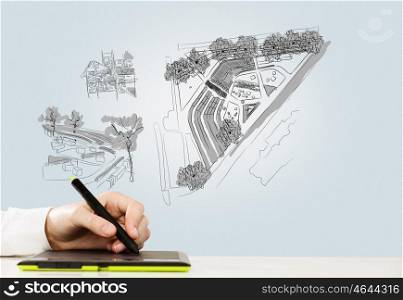 Graphic designer. Close up of man hand drawing construction sketches