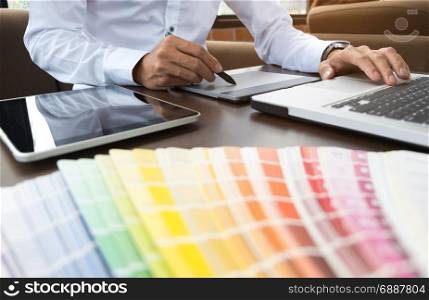 Graphic designer job with colour charts at a modern office
