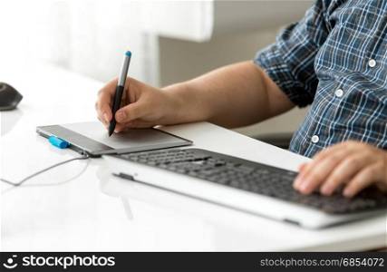Graphic designer using digital tablet at office