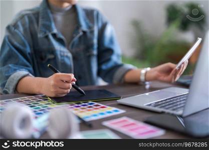Graphic designer women working on digital tablet while selection color to designing graphic design.