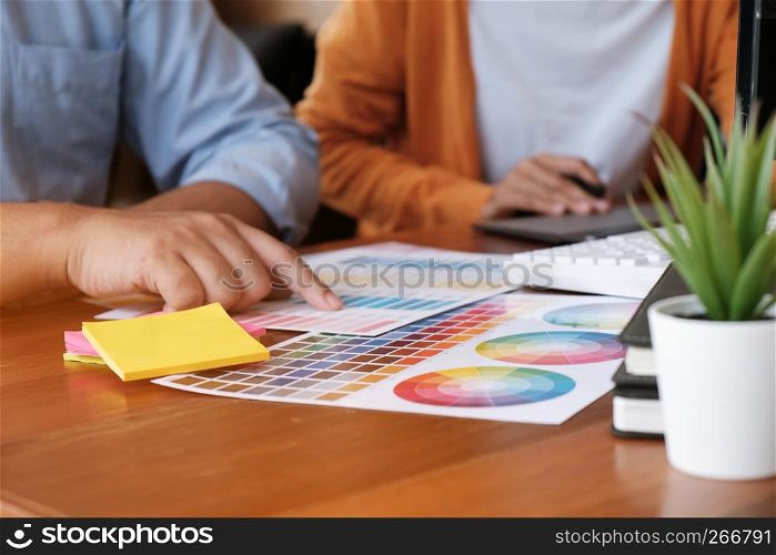 Graphic designer working on digital tablet. artist drawing on graphic tablet and Color swatch samples