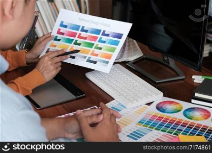 Graphic designer working on digital tablet. artist drawing on graphic tablet and Color swatch samples