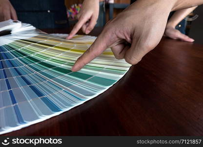 Graphic designers choose colors from the color bands samples for design .Designer graphic creativity working concept.