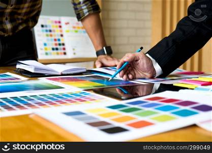 Graphic designers use the tablet to choose colors from the color bar example for design ideas, Creative designs of graphic designers concept.