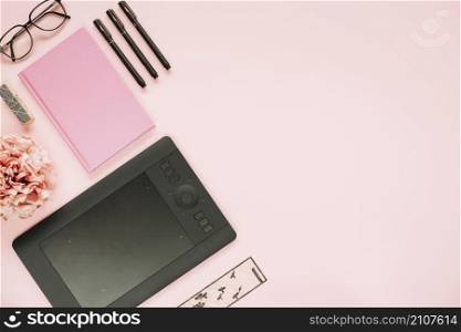 graphic digital tablet stationeries pink background