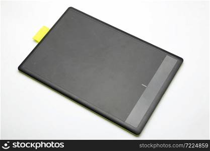 Graphic tablet lies on a white background.. Graphic tablet on a white background.