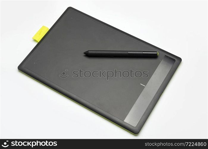 Graphic tablet lies on a white background.. Graphic tablet on a white background.