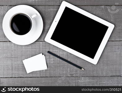 Graphic tablet with pencil paper cards and coffee on office desk