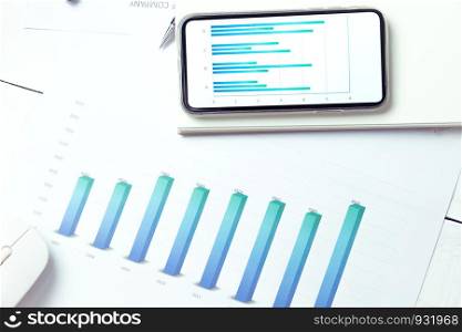 Graphs and charts elements on phone screen and statistical performance of the company.
