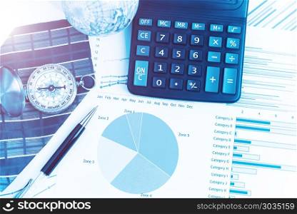 Graphs, charts, calculator, pen, compass on business table. The . Graphs, charts, calculator, pen, compass on business table. The workplace of business people. Blue color tone.