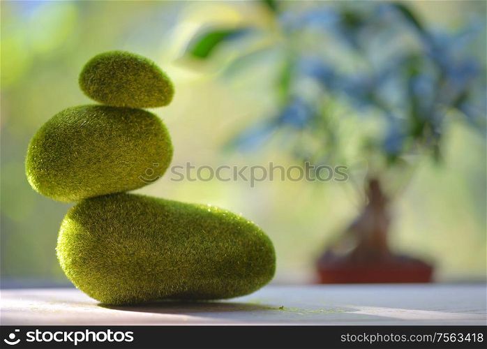 Grass green stack of pebble stones on table