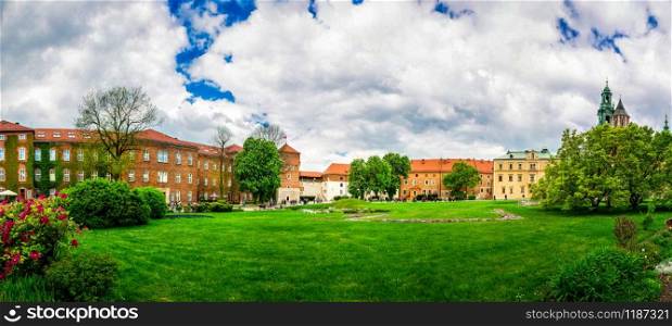 Grass lawn in Wawel castle, panoramic view, Krakow, Poland. European town with ancient architecture buildings, famous place for travel and tourism. Grass lawn in Wawel castle, panoramic view