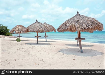 Grass umbrellas at the beach on Aruba island