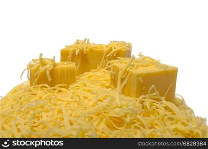 grated and chunks of hard cheese on a white background