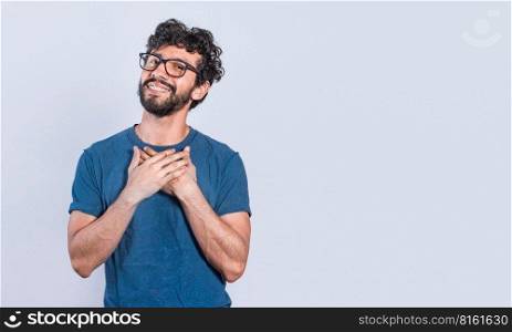 Grateful people smiling with hands on chest. Positive looking friendly handsome man with charming sincere smile feeling thankful, relaxed person with thanks gesture with hands on chest.