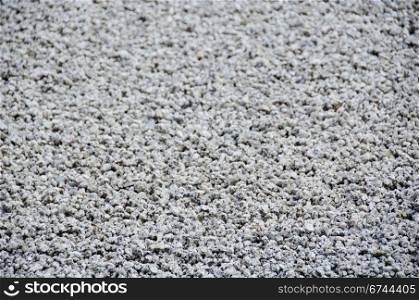 Gravel background. Background of gravel arranged in lines in a stone garden of a zen buddhist temple