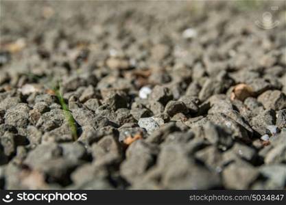 gravel background, grey gravel rocks and some brown old leaves
