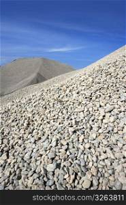 gravel gray mound quarry stock blue sky rolling stones