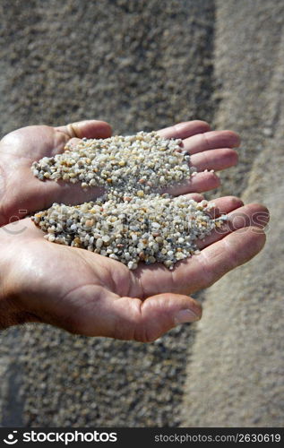 gravel sand in man hands in quarry showing camera