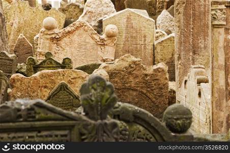 Gravestones in the historic cemetery in the Josefov ghetto area of central Prague tilt and lean together as they have settled over centuries.