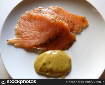 gravlax and sauce on a white plate