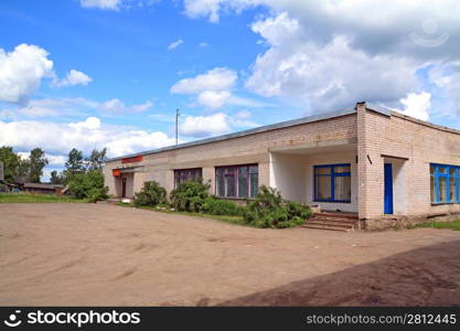 gray brick building on rural street