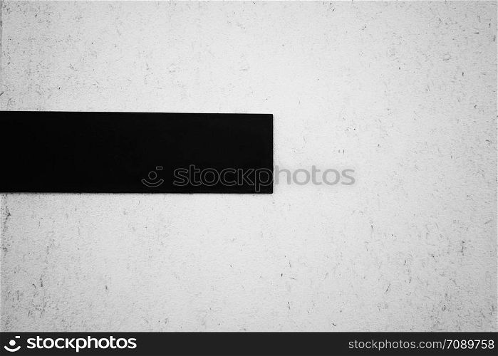 Gray Cement wall and empty black plastic sign for design in your work concept.