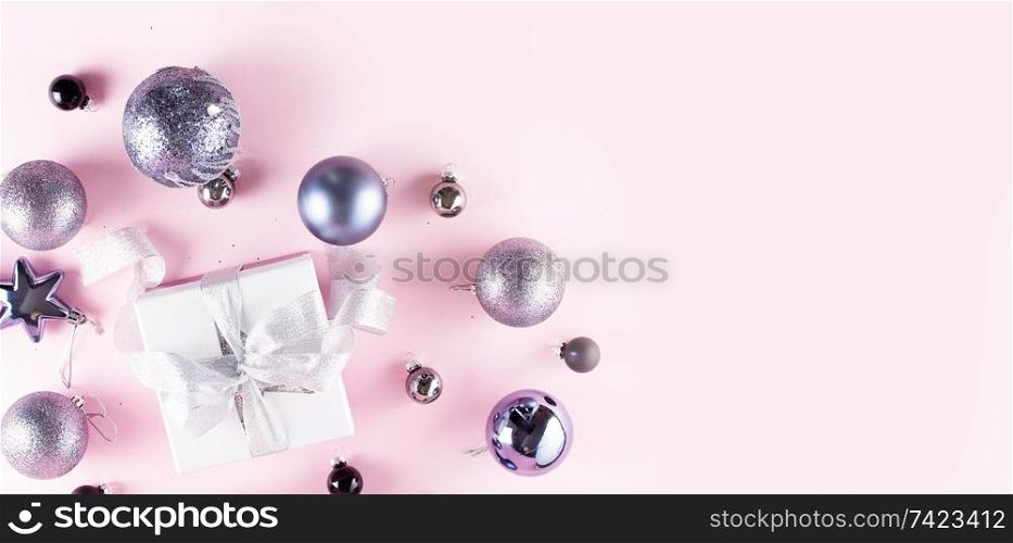 Gray Christmas decorations with gift box on pink banner. Gray Christmas decorations on pink