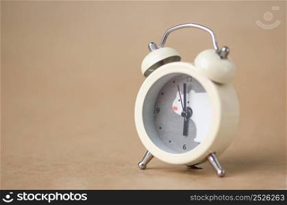 gray clock with a bear pattern on a brown blurred background. clock with an animal print