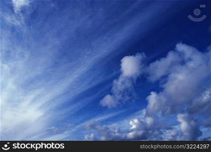 Gray Clouds Streaking Through A Blue Sky