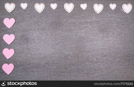 gray granite background with pink and white hearts for valentines day. Valentine&rsquo;s day and love concept.. gray granite background with pink and white hearts for valentines day. Valentine&rsquo;s day and love concept