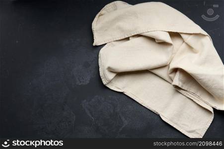 gray linen kitchen towel on a black table top view, copy space