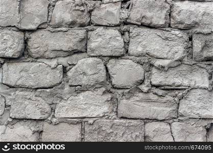 Gray old wall made of aerated concrete blocks. Texture, background.