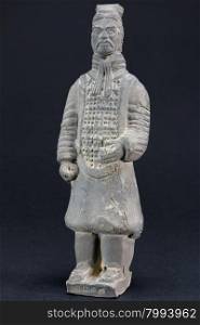 gray oriental man statuette over black background